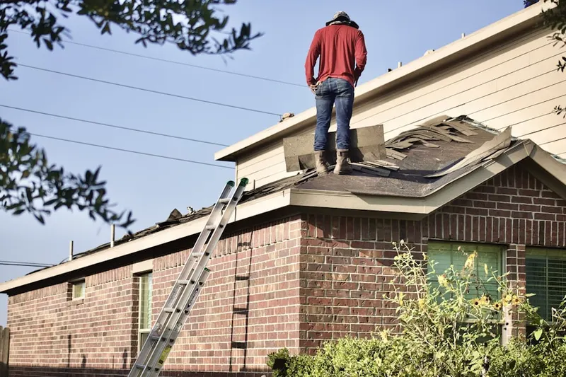 Professional roofer working on a residential roof in Grove Park- Sunset